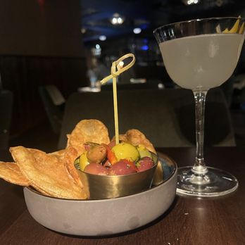 Alessa Cucina & Bar - House made chips and marinated olives with a Amalfi 75 - Italian Near Me - New York, New York Alessa Cucina & Bar - House made chips and marinated olives with a Amalfi 75 - Italian Near Me - New York, New York