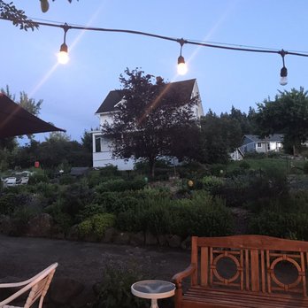 Nourish Sequim - Eating outside. One view overlooks valley and ocean below while the other view is this charming house with beautiful garden. - Gluten-Free Near Me - Sequim, Washington