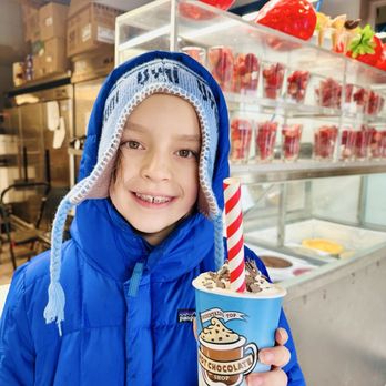 Mountain Top Cookie Shop - Customer with hot chocolate inside the establishment. - Desserts Near Me - Breckenridge, Colorado