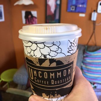 Sip Coffee House - a person holding a cup of coffee - Coffee & Tea Near Me - Highland, Indiana