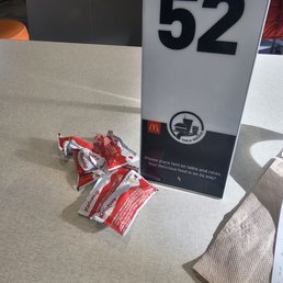 a bag of chips and a sign on a table a bag of chips and a sign on a table