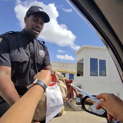 Security guard accepting the Uber Eats order after drivers were denied access.