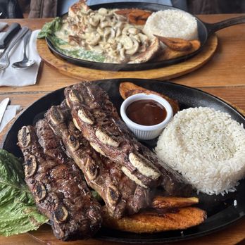 La Choza Del Gordo - Beef ribs with sweet plantains and rice.  [Across] Chicken and mushrooms with sweet plantains and rice. - Colombian Near Me - Bellerose, New York