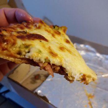 Nouveau Crystal Rest - a hand holding a slice of pizza - Breakfast & Brunch Near Me - Montreal, Quebec
