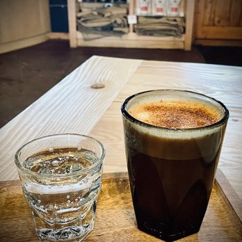 Bivouac Coffee - a glass of water and a drink - Coffee Roasteries Near Me - Evergreen, Colorado