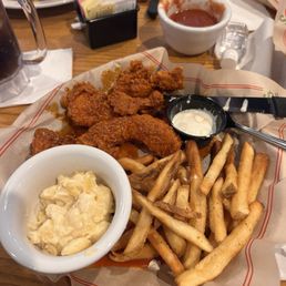 Nashville hot chicken tenders with macaroni and cheese with fries. Nashville hot chicken tenders with macaroni and cheese with fries.