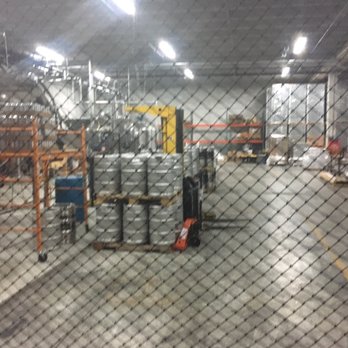 Tripping Animals Brewing - Tennis net providing the minimum legal requirements for separating patrons - Breweries Near Me - Doral, Florida
