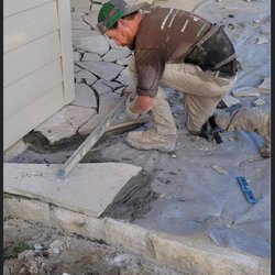 Landscape & Irrigation Masters - Owner Adam Paquette of Landscape and irrigation masters personally installing a Mexican cream flagstone patio