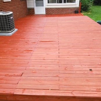 Pro Home Services - a wood deck with air conditioner - General Contractors Near Me