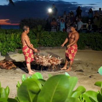 Germaine's Luau - pulling the pig out of the pit - Hawaiian Near Me - Kapolei, Hawaii