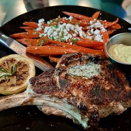Pork chop w/ sautéed carrots and goat cheese.