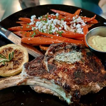Freddy’s Chophouse - Pork chop w/ sautéed carrots and goat cheese. - American Near Me - San Diego, California