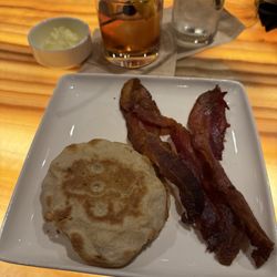 Breakfast of champions before flight. Side bacon, English muffins and old fashioned.