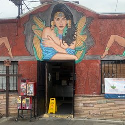 Current facade: the corn maiden. Very well painted mural corner of Brannick/Fisher street parking only.