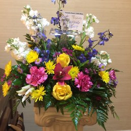 Crystal cross surrounded by beautiful flowers Crystal cross surrounded by beautiful flowers