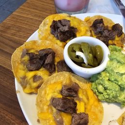 Fajita beef nachos with a "swirl" frozen margarita in the background. Fajita beef nachos with a "swirl" frozen margarita in the background.