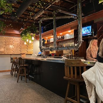 Jackie O's Brewpub - a woman sitting at a bar - Brewpubs Near Me - Athens, Ohio