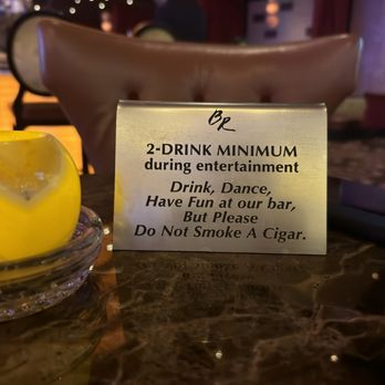 Eight75 - a sign on a table with a drink - Lounges Near Me - Biloxi, Mississippi