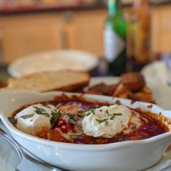 Italia Trattoria - Baked Eggs. Tangy, hearty, savory. The polenta brings a great texture, and it's served with bread + potatoes.