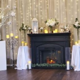 Front ceremony area with beautiful candles, lights, fireplace and flowers. Front ceremony area with beautiful candles, lights, fireplace and flowers.