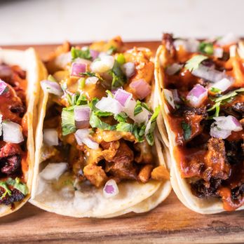 Tequileros Taqueria - three tacos on a cutting board - Tacos Near Me - Stockton, California Tequileros Taqueria - three tacos on a cutting board - Tacos Near Me - Stockton, California