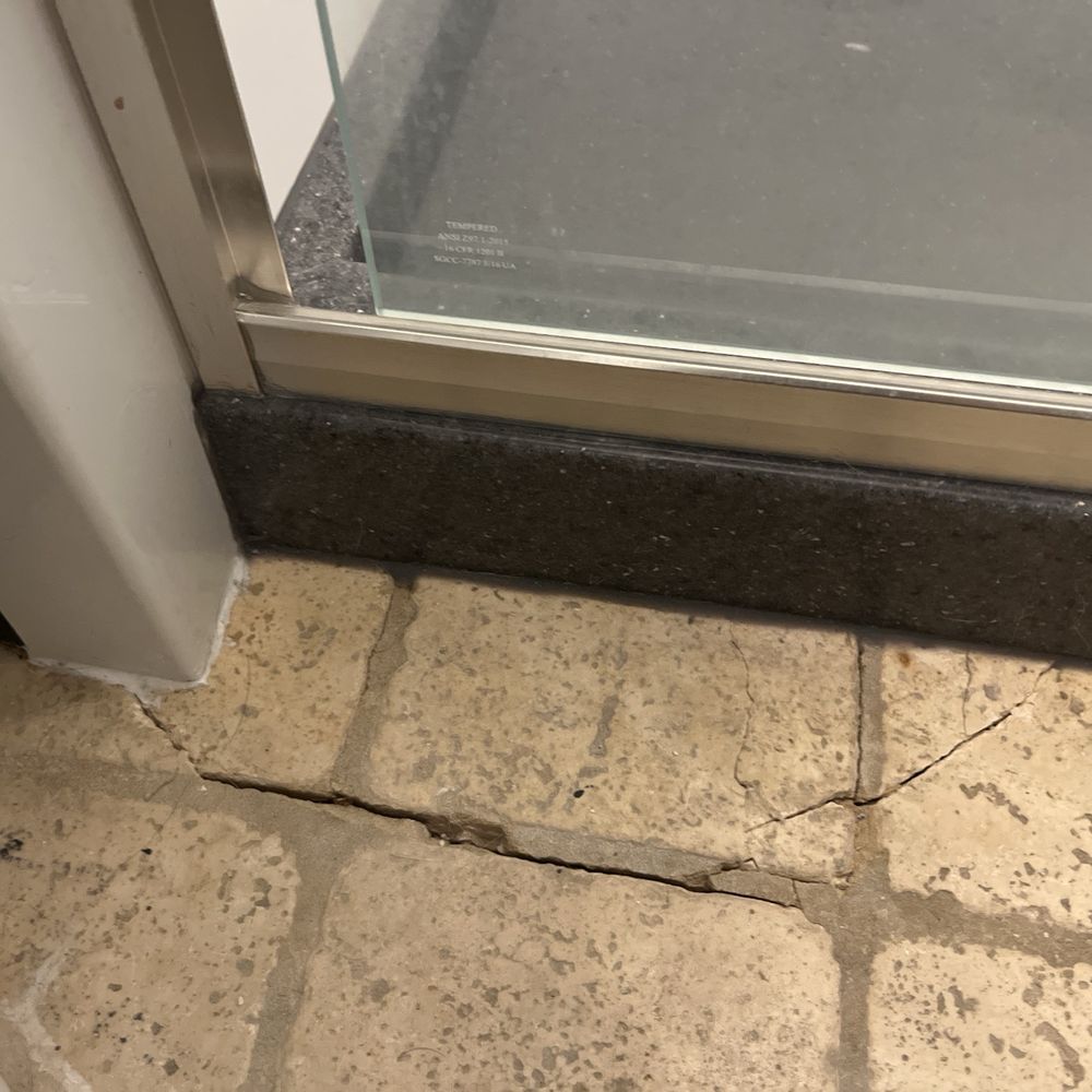 Bay State Bath - Cracked floor tile next to shower - General Contractors Near Me - Pembroke, Massachusetts Bay State Bath - Cracked floor tile next to shower - General Contractors Near Me - Pembroke, Massachusetts