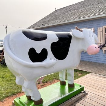 COWS - a white and black cow on a green platform - Ice Cream & Frozen Yogurt Near Me - Charlottetown, Prince Edward Island COWS - a white and black cow on a green platform - Ice Cream & Frozen Yogurt Near Me - Charlottetown, Prince Edward Island