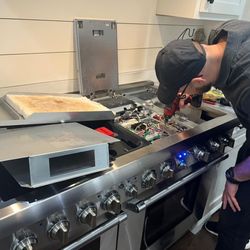Appliance Tech Pros & Refrigeration Repair - One of our specialists doing a cooktop oven repair.