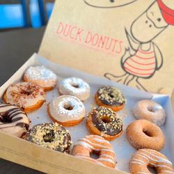 Duck Donuts - Assorted: Includes - Coffee Cake, Peanut Butter Paradise, Bacon in the Sun, French Toast, Coconut Island Bliss.