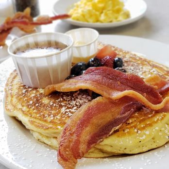 At The Corner - a stack of pancakes with bacon and blueberries - Salad Near Me - Little Rock, Arkansas At The Corner - a stack of pancakes with bacon and blueberries - Salad Near Me - Little Rock, Arkansas