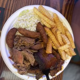 Plate with brisket and pulled pork - fries, hush puppies, and white slaw Plate with brisket and pulled pork - fries, hush puppies, and white slaw