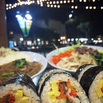 Manna Grill - Kim Bap with Bulgogi (front), Jap Chae (far left), and Bibimbap (far right) - Korean Near Me - Riverside, California Manna Grill - Kim Bap with Bulgogi (front), Jap Chae (far left), and Bibimbap (far right) - Korean Near Me - Riverside, California
