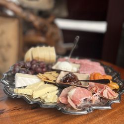 Black Cat Frozen Custard - Charcuterie board: Bread, Fig Jam, Apricots, Salami, Gouda, Brie, Prosciutto, and Grapes.
