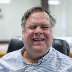 Vision Forward Association - Max has a smiling face and and is a visually impaired receptionist at the vision forward front desk.