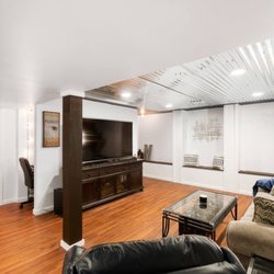 Square East building - Build out for a bright basement living space. The metal ceiling really transformed this space! Storage in the benches to keep it tidy!