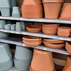 Ace Hardware - Plastic pots and saucers in nursery area