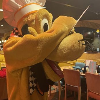 Goofy's Kitchen - Pluto signing our photo mat. - American Near Me - Anaheim, California