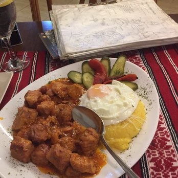 Dracula - Tochitura.  Romanian stewed meat- pork and sausages, served with polenta and an egg on top - Spanish Near Me - Calp, A