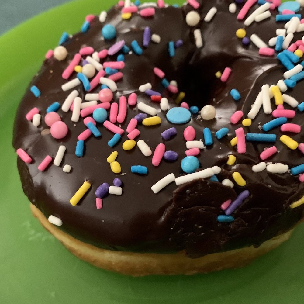 Delicious Chocolate donut with sprinkles Delicious Chocolate donut with sprinkles