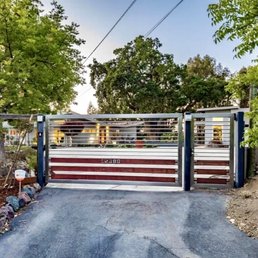 Driveway and pedestrian gate, stainless steel and stained redwood.