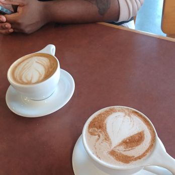 Yellow Dog Coffee - Lavender latte on the left and a Chai latte on the right - Coffee Roasteries Near Me - Norman, Oklahoma Yellow Dog Coffee - Lavender latte on the left and a Chai latte on the right - Coffee Roasteries Near Me - Norman, Oklahoma