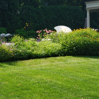 CM Landscaping - a lawn with flowers and a white umbrella - Snow Removal Near Me - New City, New York CM Landscaping - a lawn with flowers and a white umbrella - Snow Removal Near Me - New City, New York