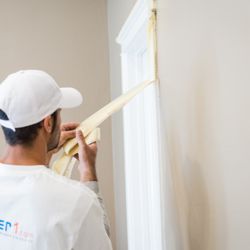 Painter 1 - Taping to ensure clean lines.