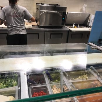 Cosi - a woman preparing food in a kitchen - Sandwiches Near Me - Baltimore, Maryland Cosi - a woman preparing food in a kitchen - Sandwiches Near Me - Baltimore, Maryland