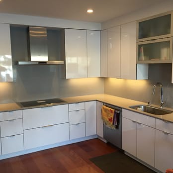 Elaborate Builders - a kitchen with white cabinets and stainless steel appliances - General Contractors Near Me Elaborate Builders - a kitchen with white cabinets and stainless steel appliances - General Contractors Near Me