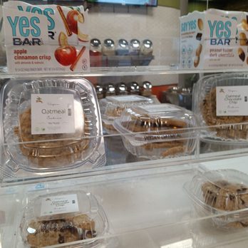 Smoothie Rx - Vegan oatmeal cookies and snack bars are arranged in clear plastic containers inside a store display case. - Juice Bars & Smoothies Near Me - Chicago, Illinois