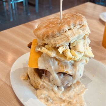 Maple Street Biscuit - The Five and Dime (with fried chicken, scrambled egg, cheddar cheese, and bacon. Smothered in sausage gravy) - Breakfast & Brunch Near Me - Wylie, Texas