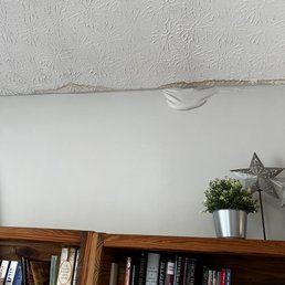 Water damage to new paint job after Able said a new roof would fix the leaks.