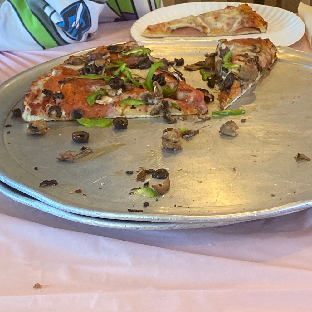 Straw Hat Pizza - half eaten pizza and half eaten pizza - Pizza Near Me - Hollister, California