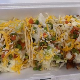 three tacos in a styrofoam container